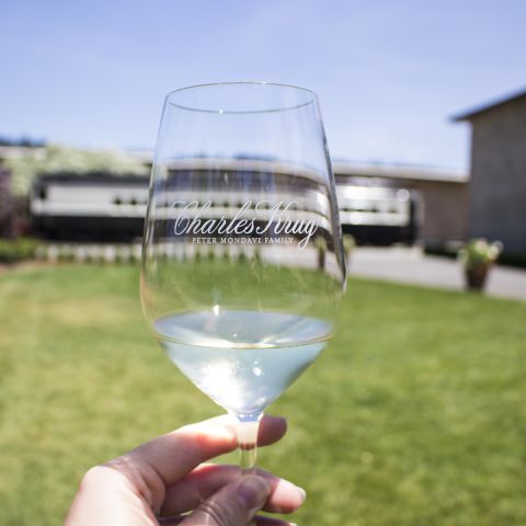 Close up of wine glass with engraving reads Charles Krug Peter Mondavi Family