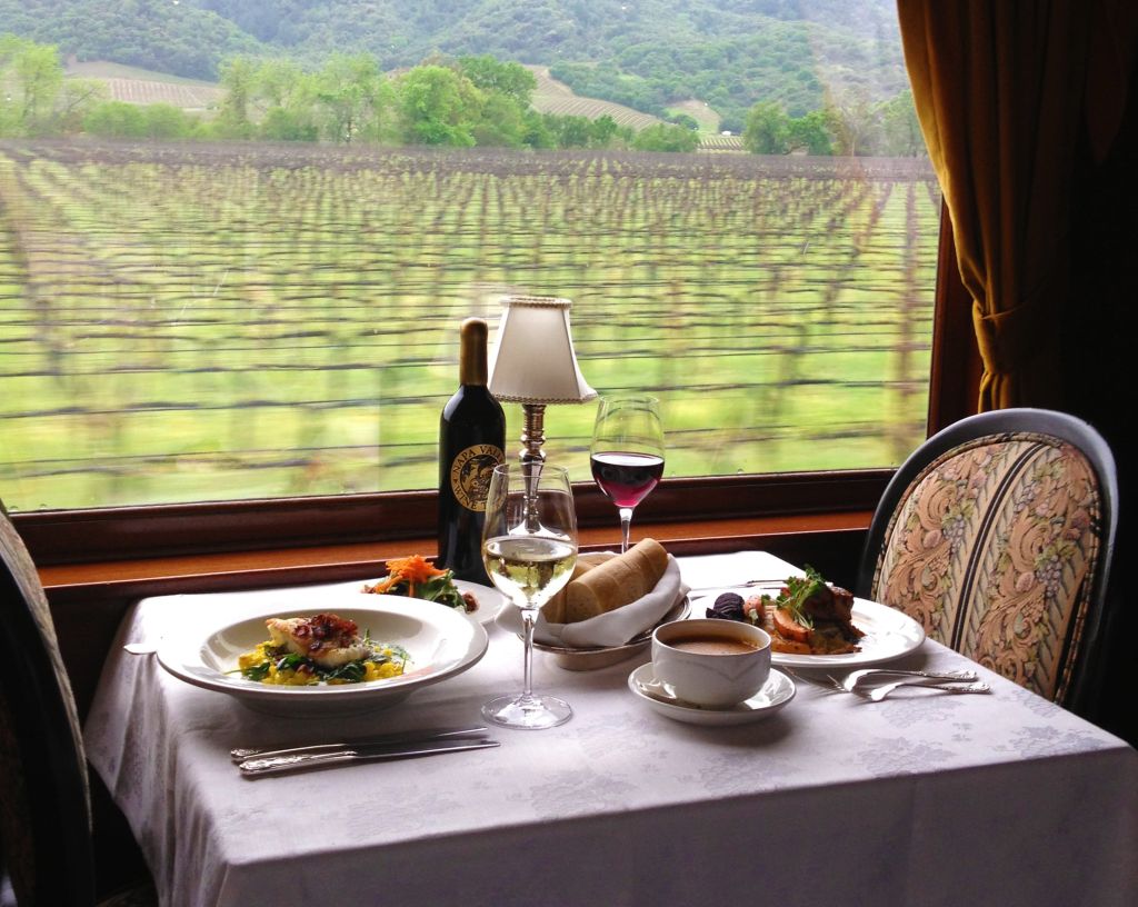 Dinner is served! Full plates and glasses of wine or coffee await guests as the Wine Train travels through vineyards
