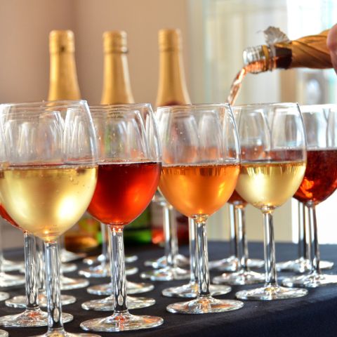 Wine being poured into wine glasses