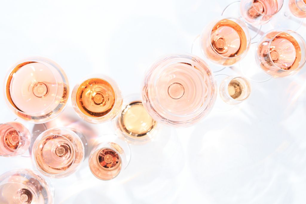 Many glasses of rose wine at wine tasting.
