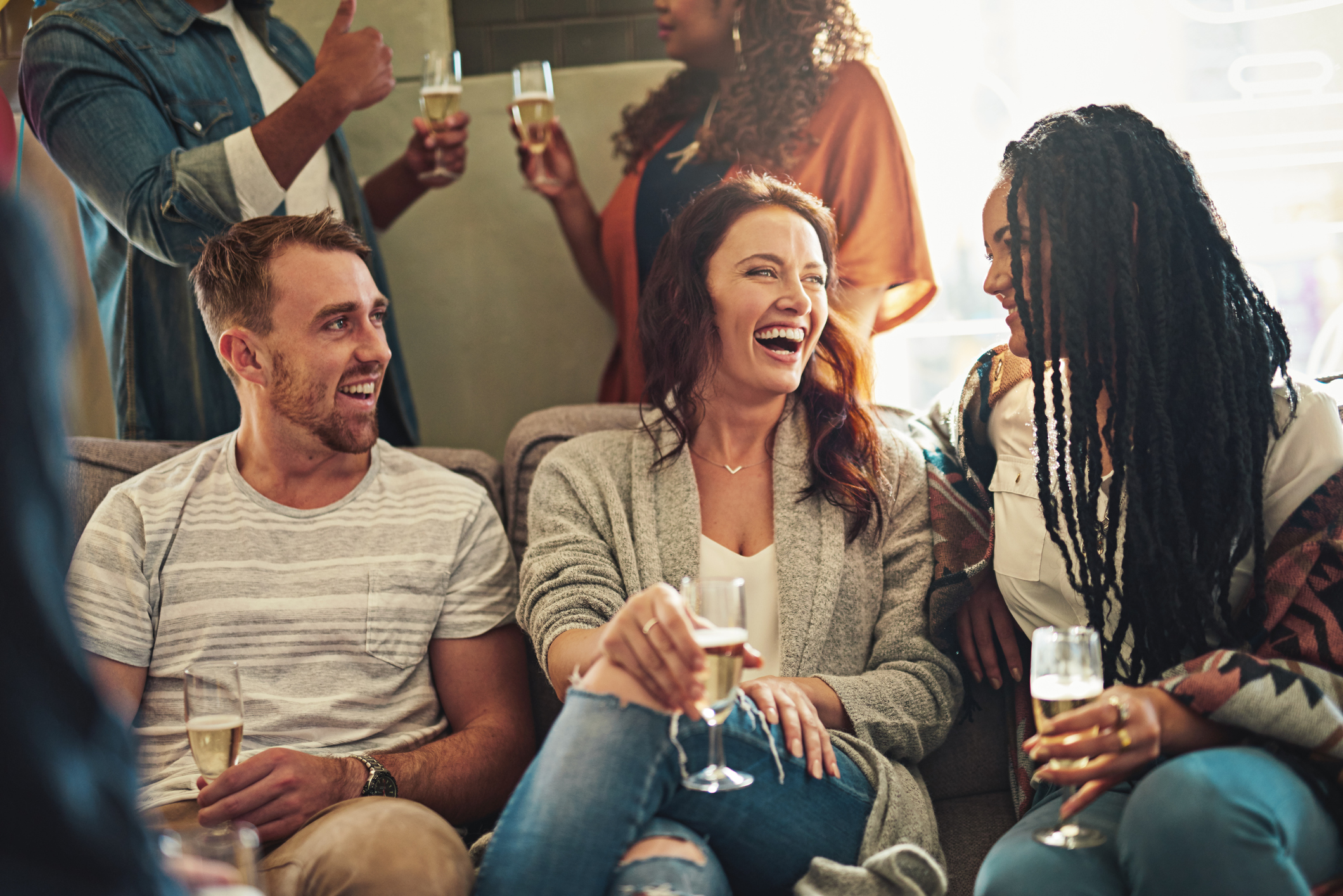 Group of friends sharing a laugh over champagne