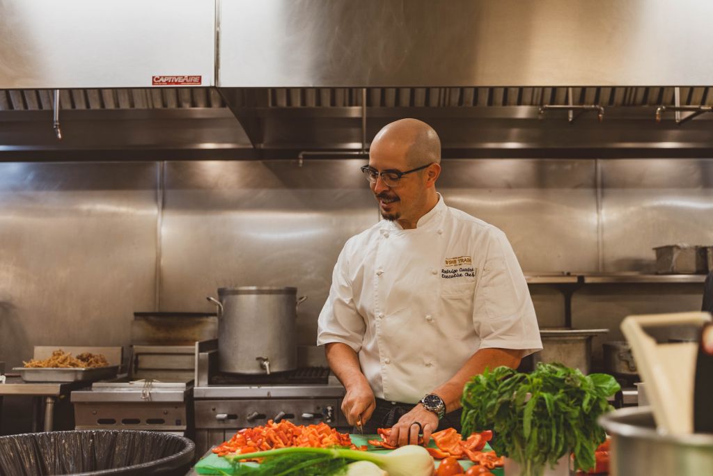 Chef dicing red peppers