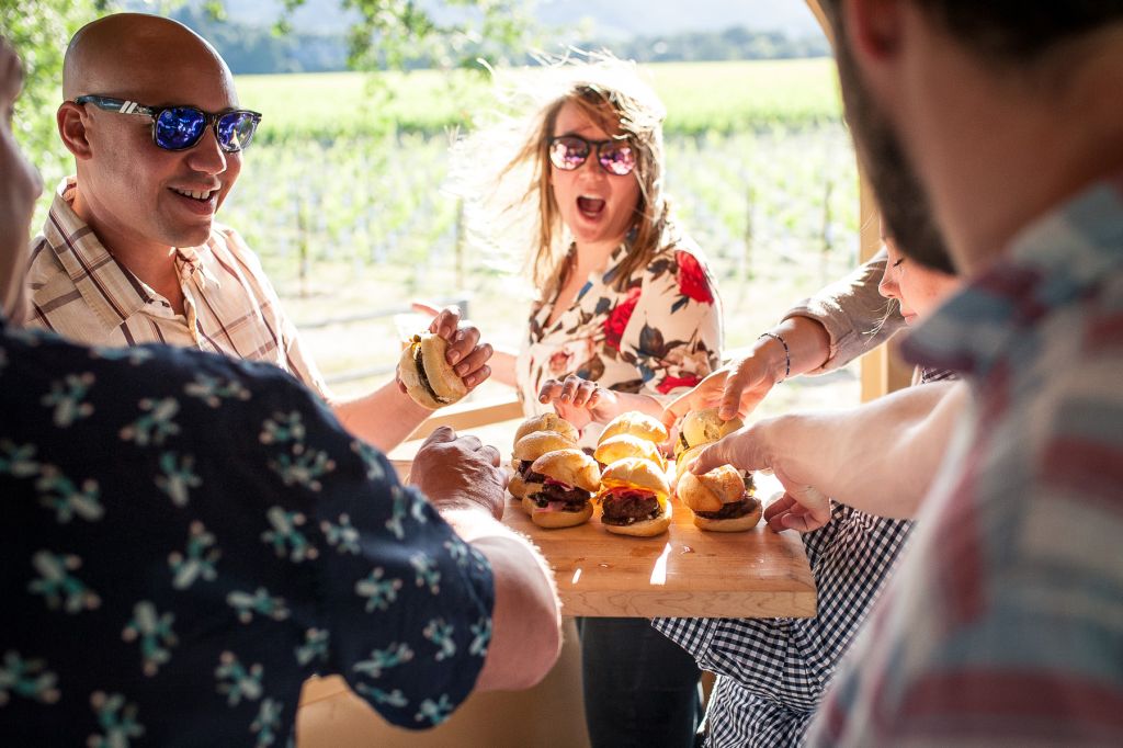 Adults sharing tray of sliders