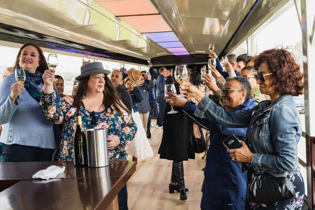 Passengers toasting their wine glasses in unison