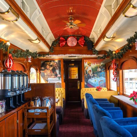 Peppermint Tea Car aboard the Napa Valley Wine Train, decorated for the holidays with festive décor and comfortable lounge seating.