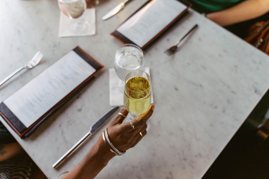 A glass of white wine held up for the camera