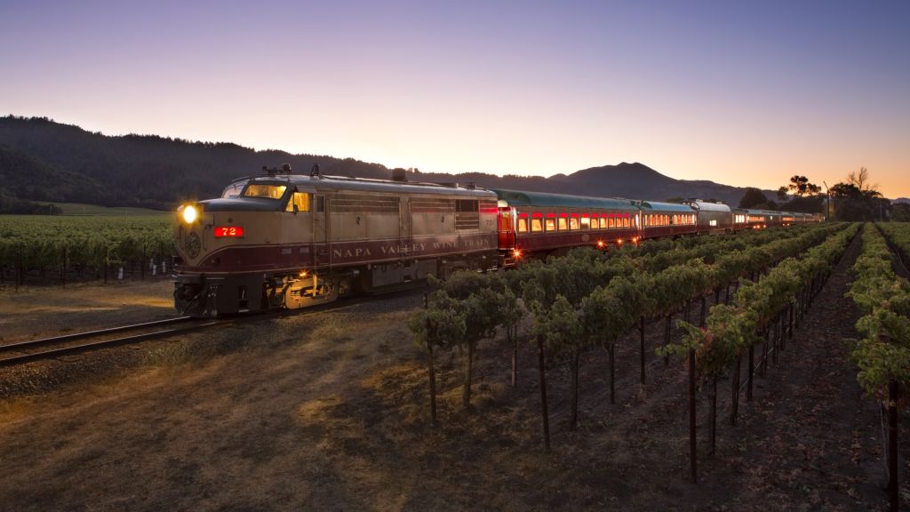 Wine Train in motion at dusk with each car lit up