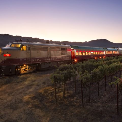 Wine Train in motion at dusk with each car lit up