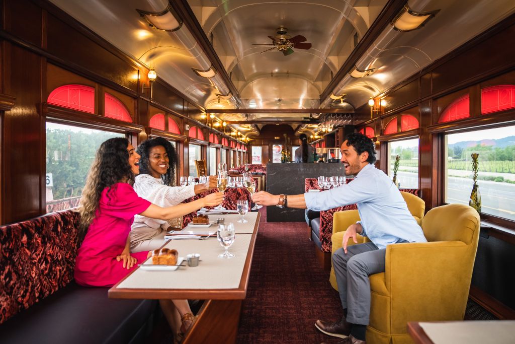 Guests clink their wine glasses in toast