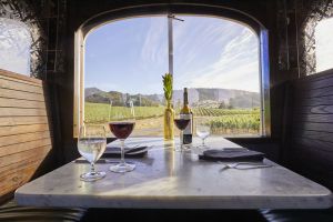 Two glasses of red wine sit atop a table aboard the Wine Train
