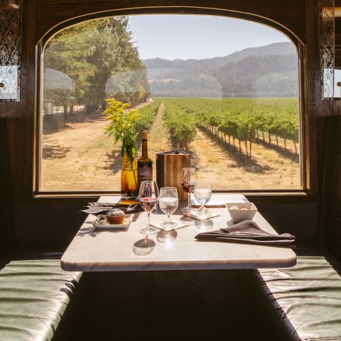 Dining car onboard the Wine Train set with food and drink
