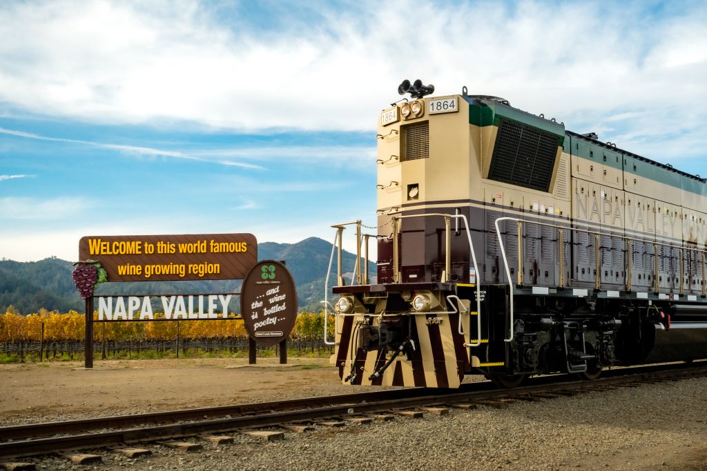 The front of the Napa Valley Wine Train stopped next to welcome sign