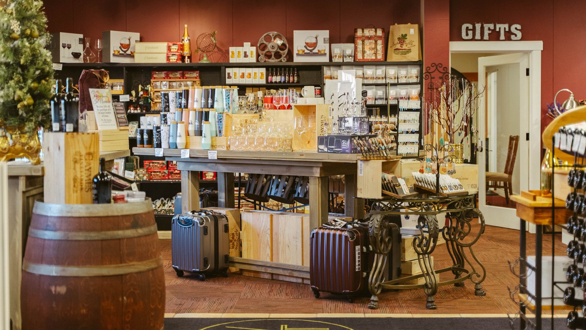 Retail Wine Store with suitcases, wine barrels and merchandise on display