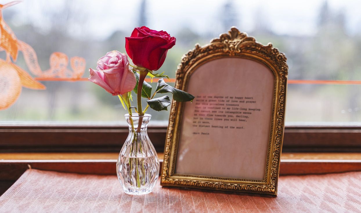 The Love Line Napa Valley Wine Train roses and frame sitting on table