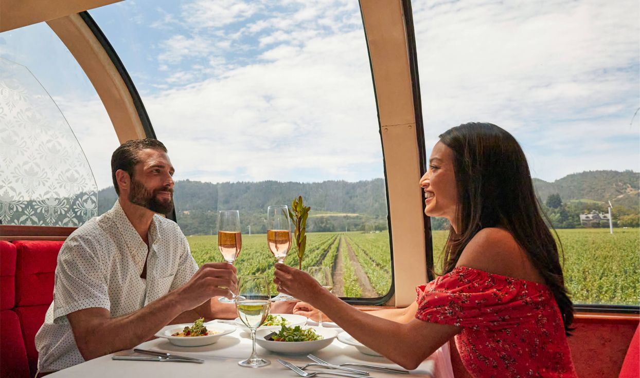 Couple raise their wine glasses in toast