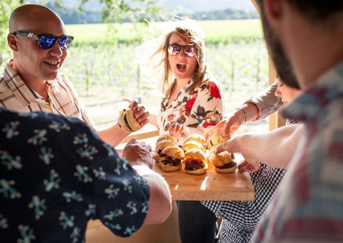 Adults sharing tray of sliders