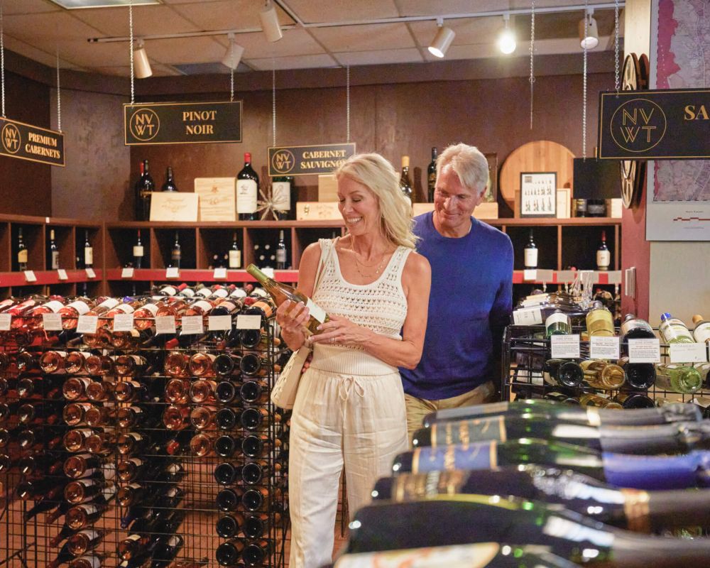 A couple peruses the wine shop