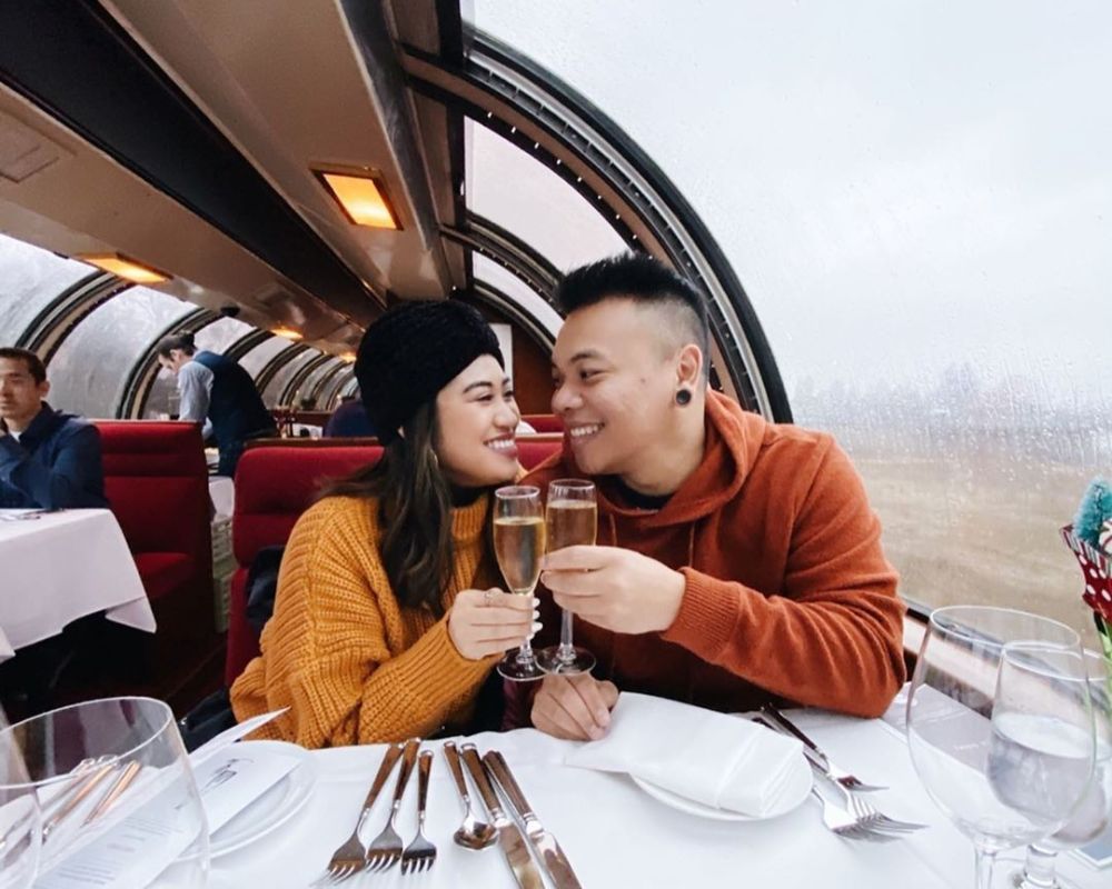 Couple toast their wine glasses