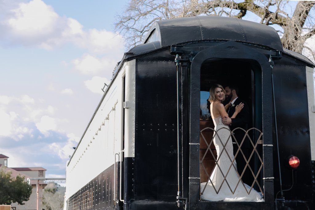 Bride and groom on the caboose