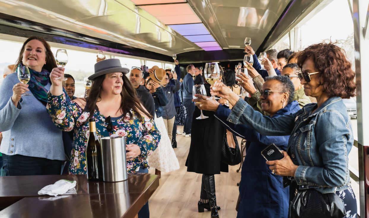 Passengers toasting their wine glasses in unison