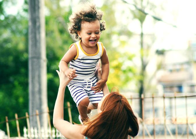 Child laughs as he's thrown into air