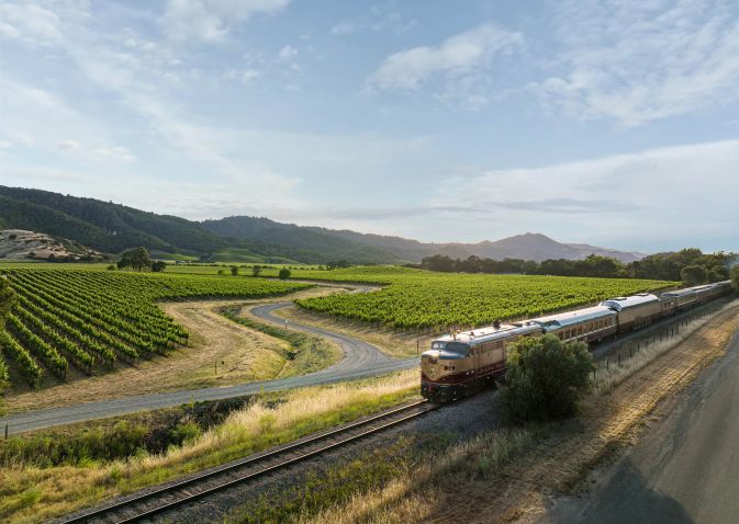 Aerial shot of Wine Train passing through Vineyards