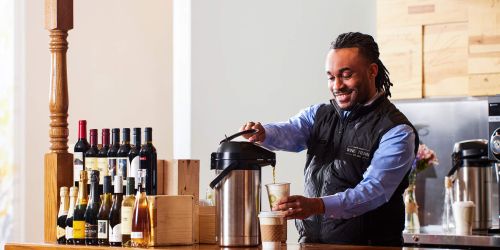 Bartender pours a cup of coffee