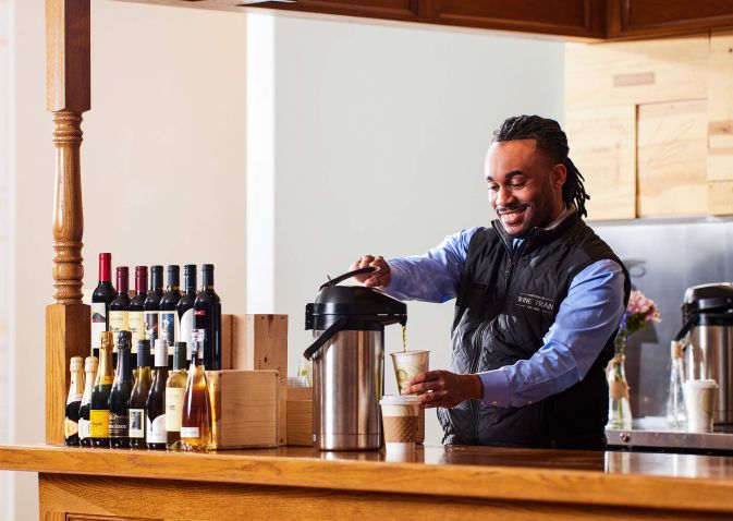 Bartender pours a cup of coffee