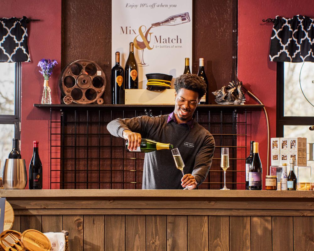 Bartender pours a glass of champagne