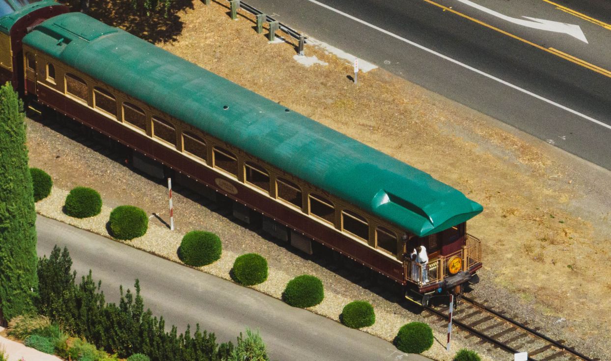 An overhead shot of the Napa Valley Wine Train. It's roof is a deep emerald green.