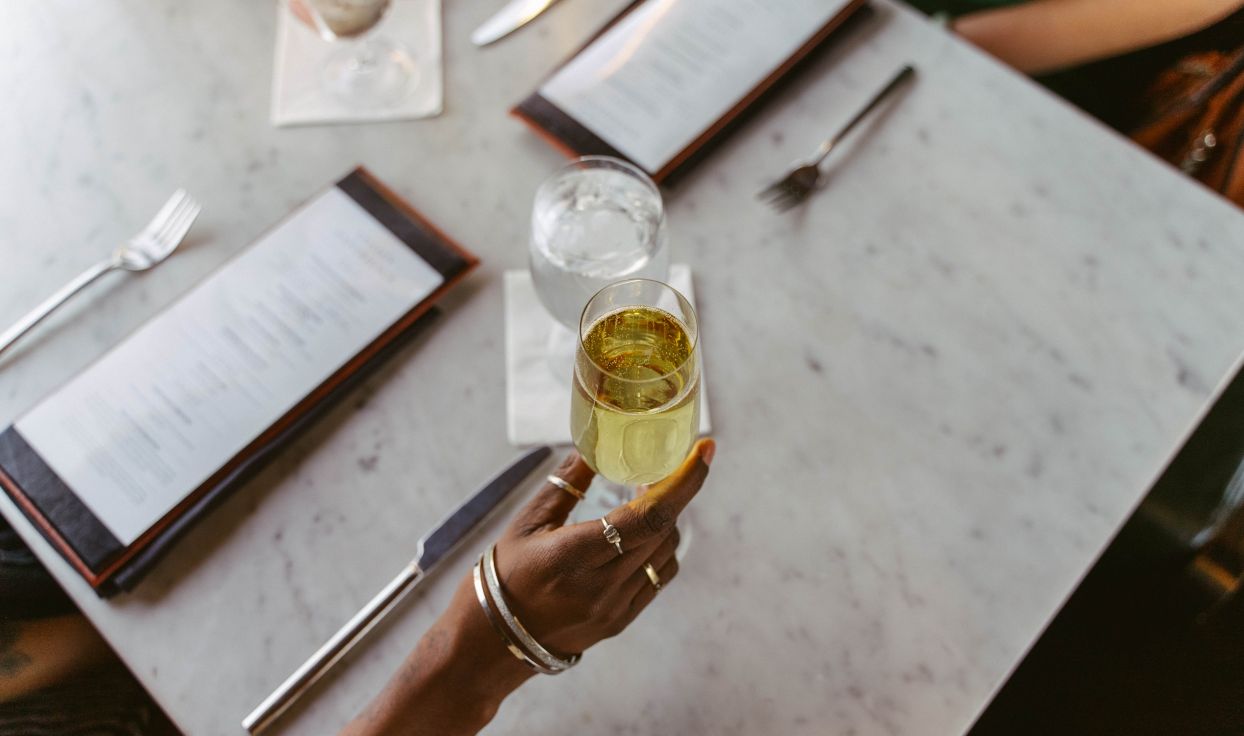 A glass of white wine held up for the camera