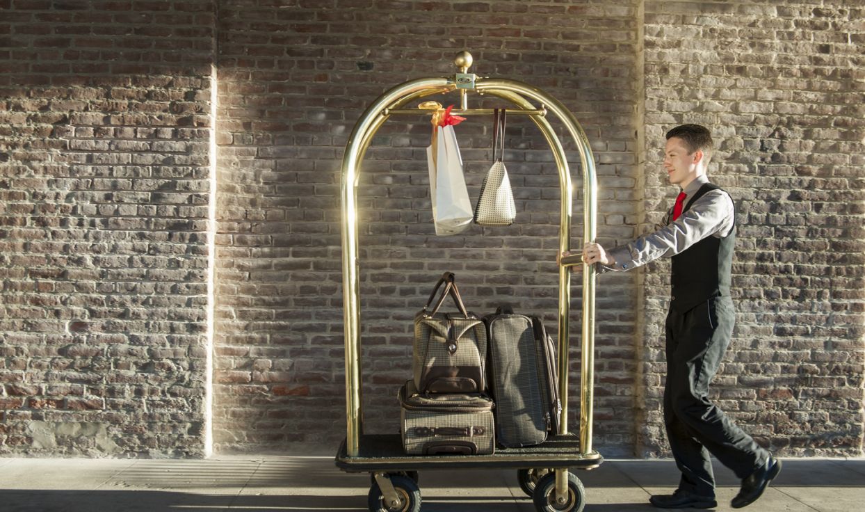 Man pushes luggage dolly