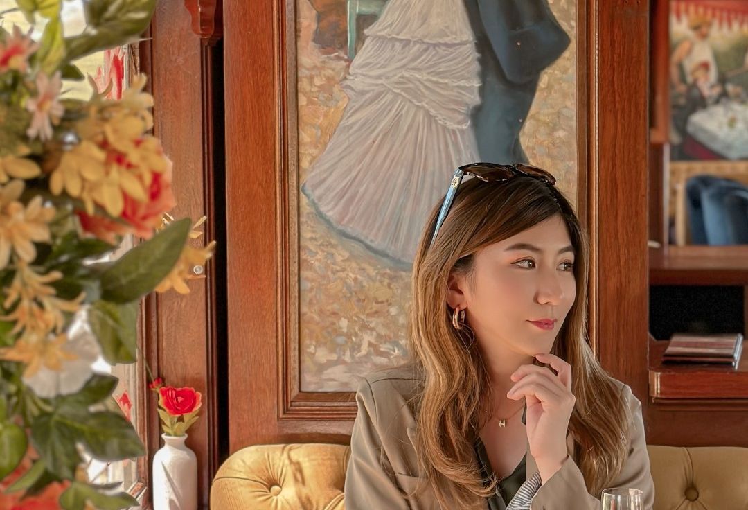 Woman with wine looks to her left