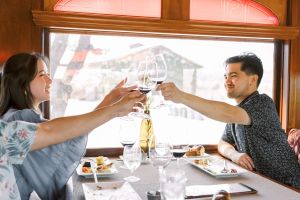 Guests clink their wine glasses in toast