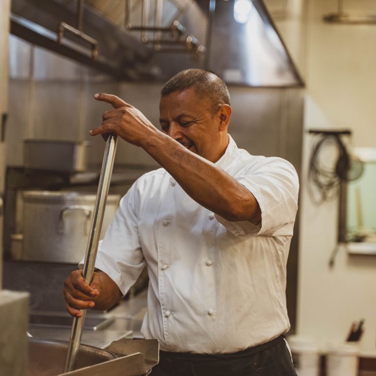 Chef stirring vat