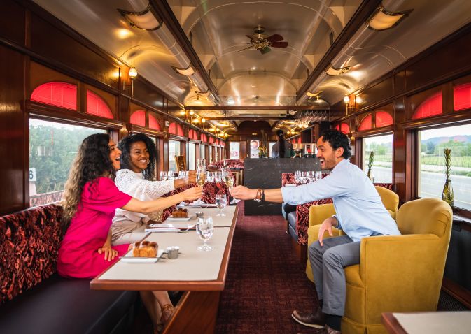 Guests clink their wine glasses in toast