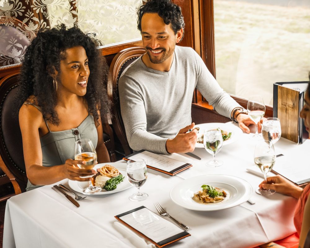 Guests enjoy their food and drink aboard the Wine Train