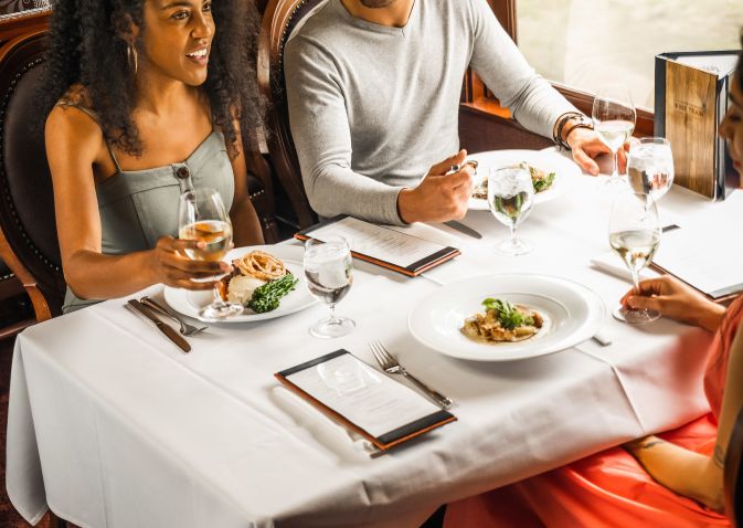 Guests enjoy their food and drink aboard the Wine Train