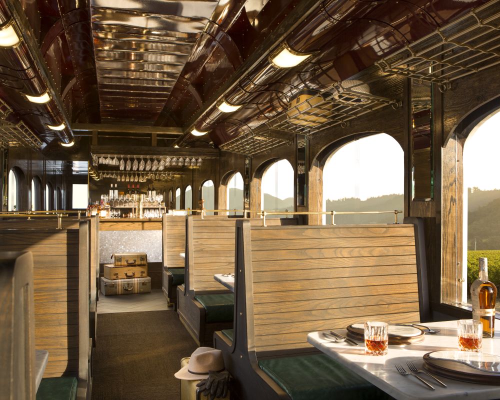 Bar car interior with wood panel backed booth seating