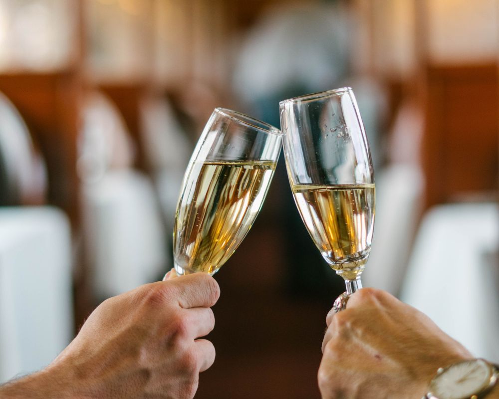 Wine glasses clinked in toast